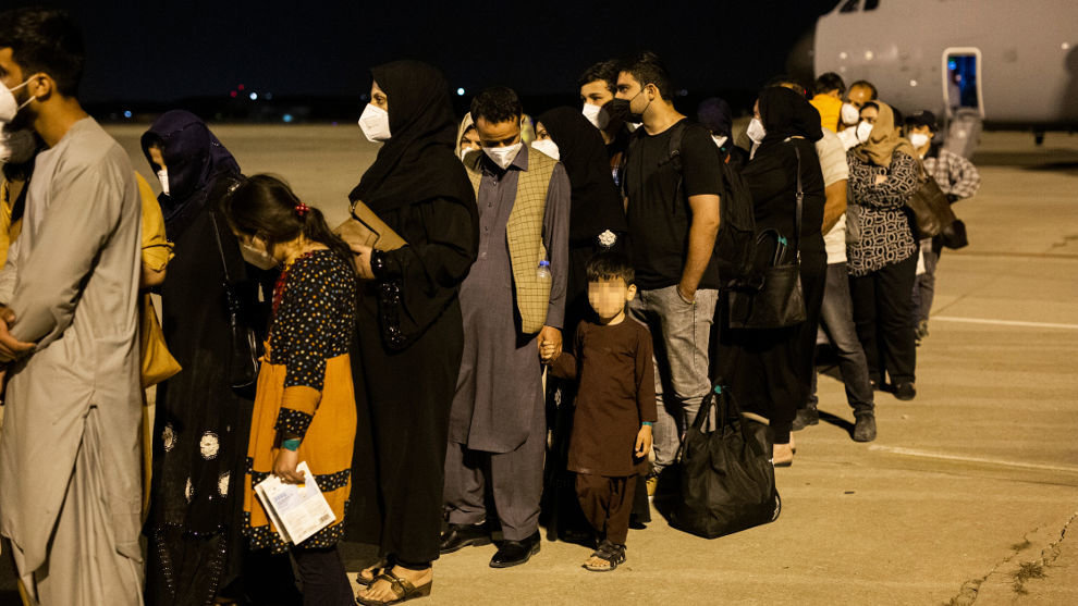 Varias personas repatriadas llegan a la pista tras bajarse del avión A400M en el que han sido evacuados de Kabul