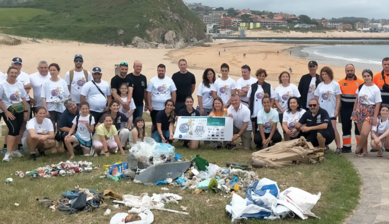 Buceadores voluntarios limpian la basura del fondo del mar en la playa de Cuch&iacute;a (Miengo) y posan con sus hallazgos