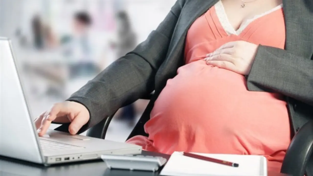 Una mujer embarazada con el ordenador