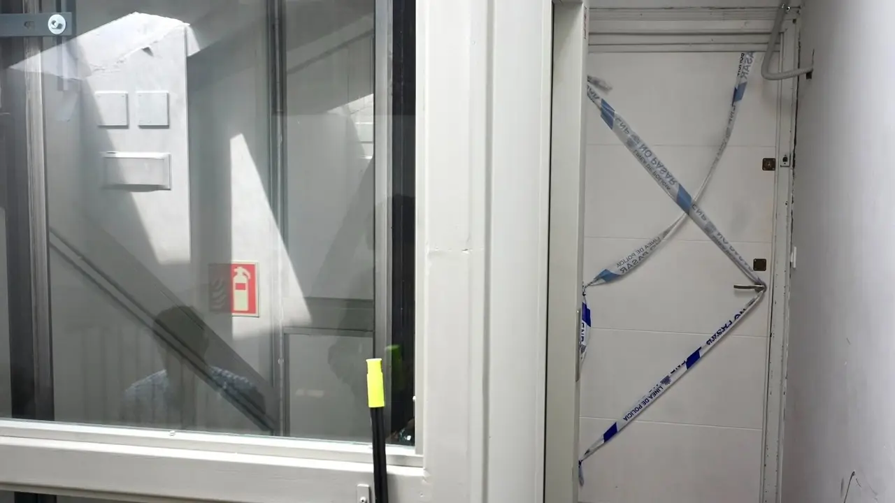 Puerta del piso de la calle Perines donde se ha producido la agresión y muerte de una mujer de 27 años preuntamente a manos de su pareja de 39. El hombre ha llamado a la Policía, ha confesado los hechos y ha quedado detenido 